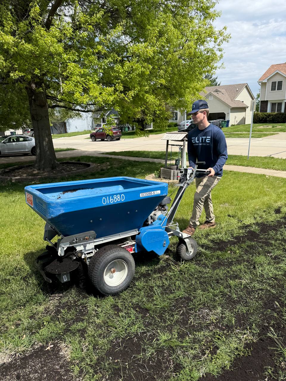 Lawn overseeding service with spreader